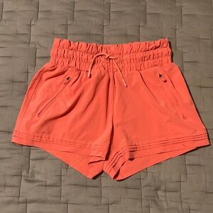 Coral Athleta Girl Shorts with Elastic Waistband and Lightweight Fabric